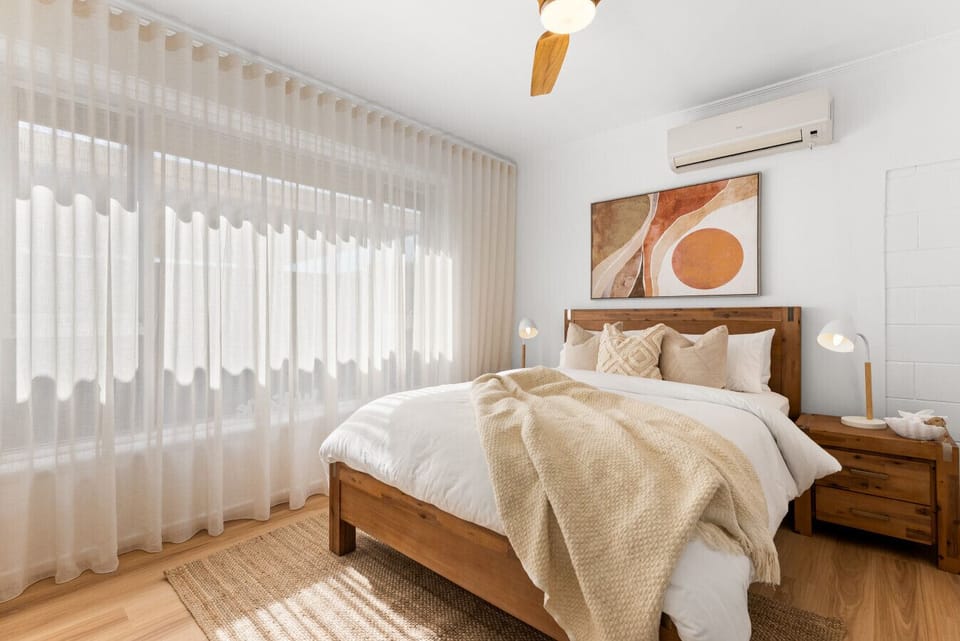 Wake to a serene queen bedroom, where crisp linens and soft coastal tones create a calming beachside retreat.