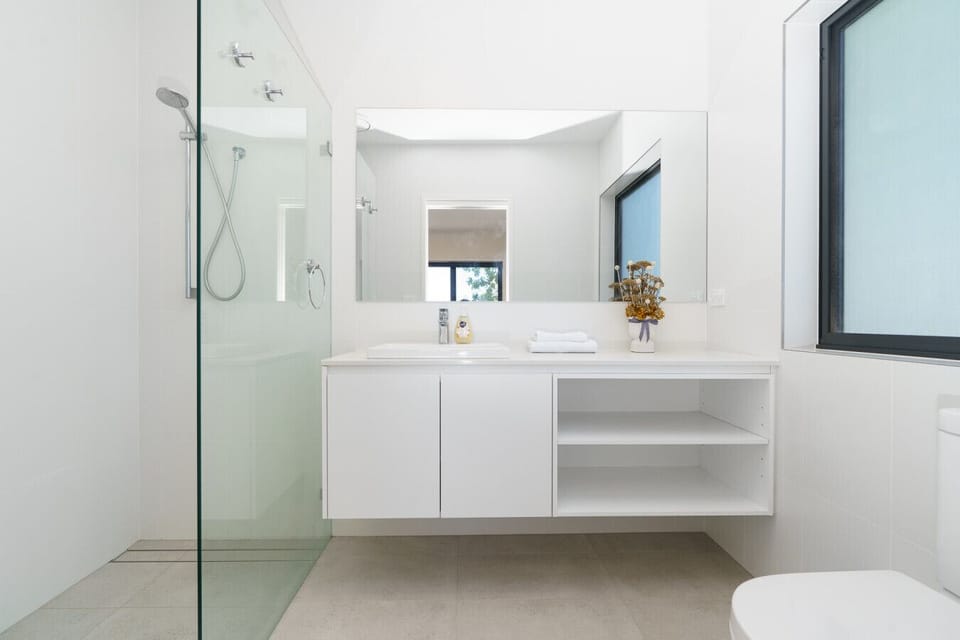 Another well-appointed bathroom offering a clean, calming space to start or end your day feeling refreshed and comfortable.