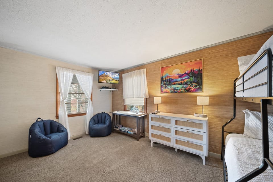 TV and Bean Bag Chairs in the Bunk with Bright Artwork