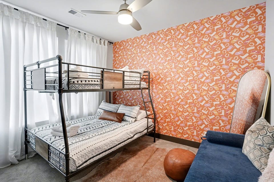 1st Floor: 2nd Bedroom featuring a Full-over-Full bunk bed, lounge chair, and a closet.