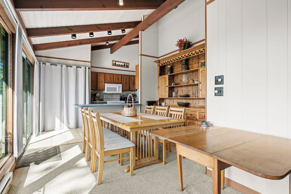 Inviting dining table perfectly positioned between the kitchen and living areas.