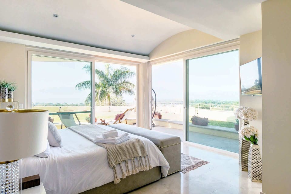 Master Bedroom |  opens to a private balcony, filling the space with natural light and lake view