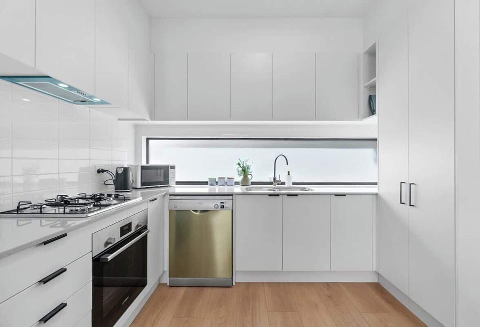The open-plan kitchen is fully equipped and offers a spacious layout, providing ample room for the whole family to cook and enjoy meals together.
