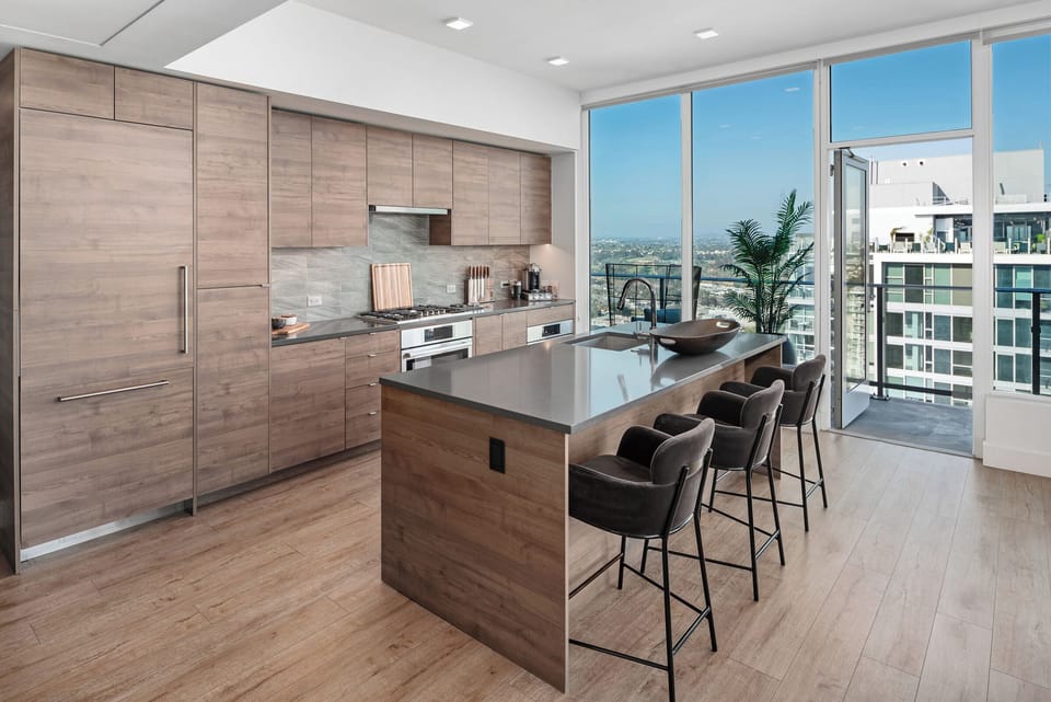 Daytime view of the kitchen with the center island and barstools.