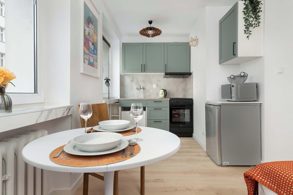 The sleek design of the kitchenette blending seamlessly with the living area.
