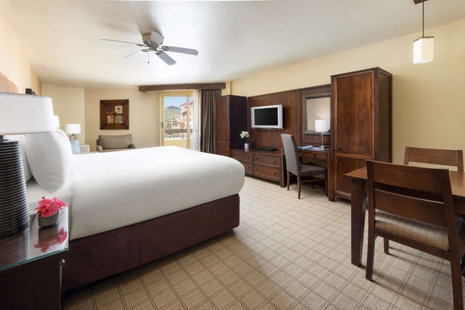Spacious king bed room with work desk and balcony view