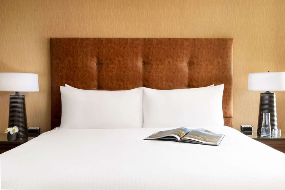 King bed with soft pillows and warm lights for a good night’s rest