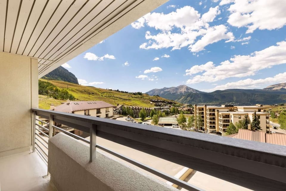 Scenic balcony overlooking mountains and village below