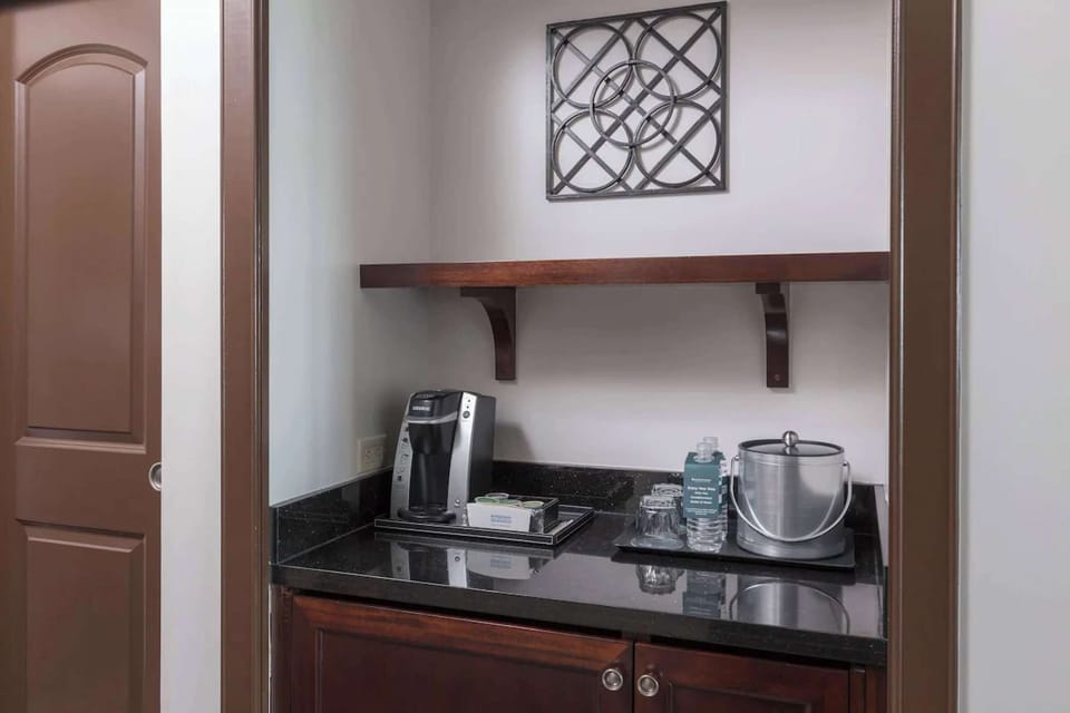 Coffee station with Keurig, water bottles, and ice bucket setup