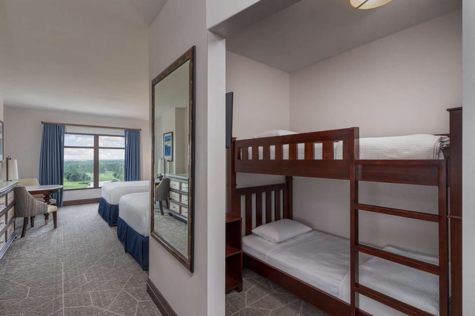 Room with bunk beds and double beds, large window