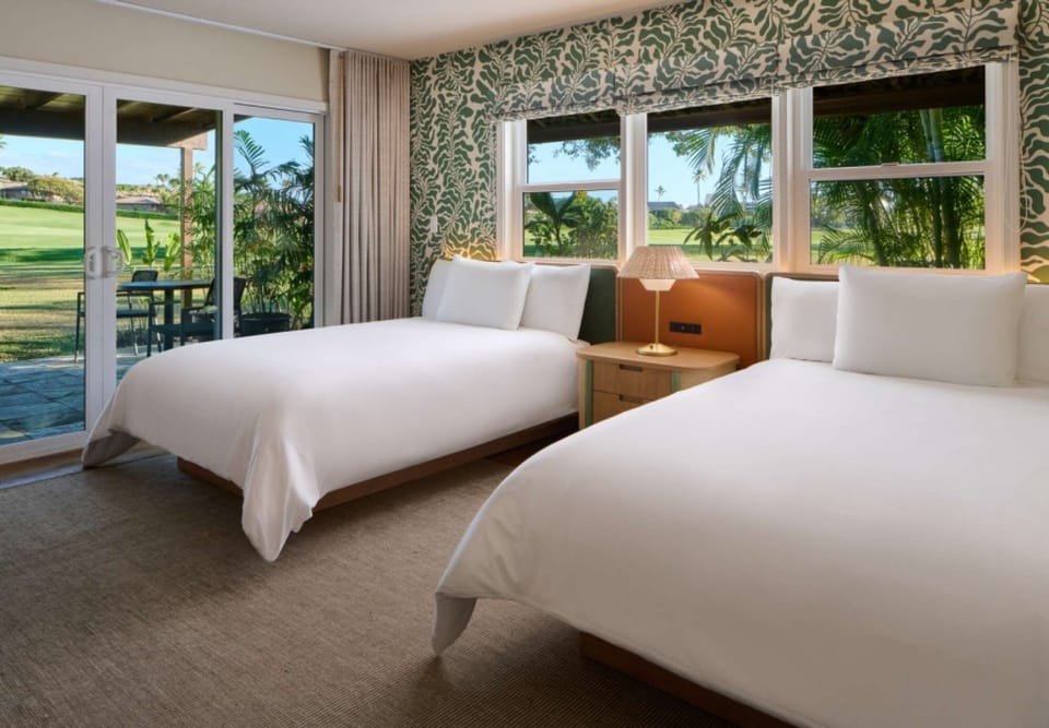 Bright room with two beds, garden views, and easy patio access