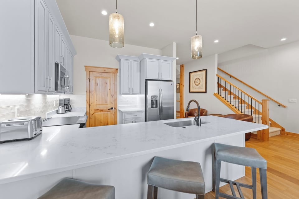Your gourmet kitchen features marble countertops, modern appliances, and elegant pendant lighting—perfect for creating memorable meals together.