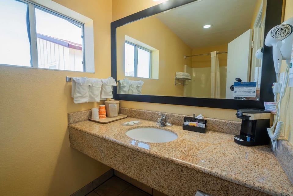 Vanity with large mirror and neatly arranged towels