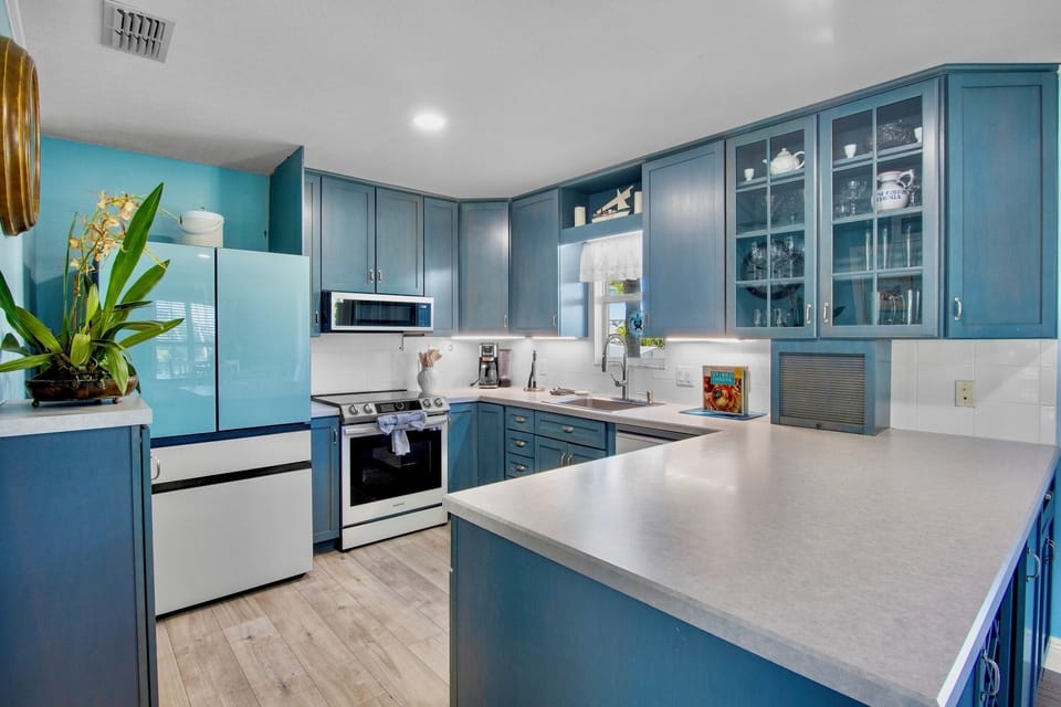 Cook your favorite meals in this bright, fully-equipped kitchen with modern appliances, abundant storage, and a spacious island perfect for meal prep.