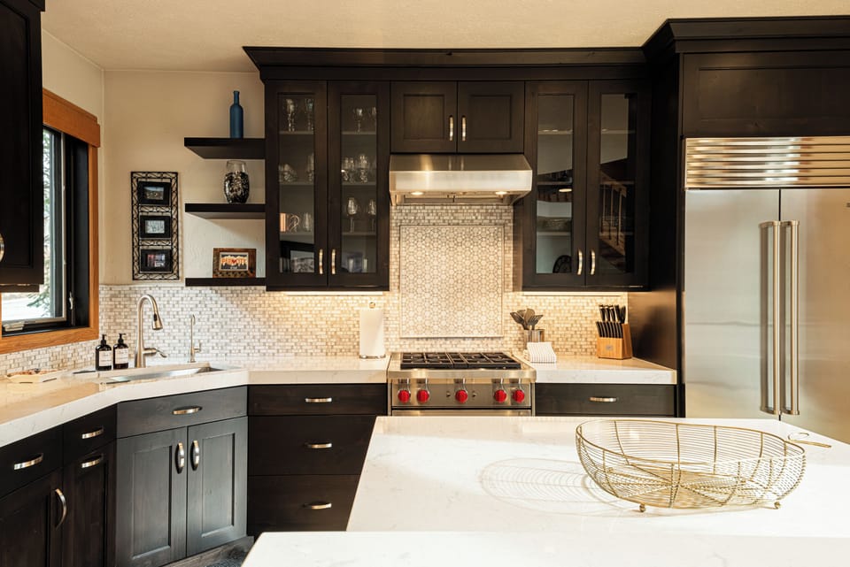 Modern kitchen featuring stainless fridge and sleek cabinetry.
