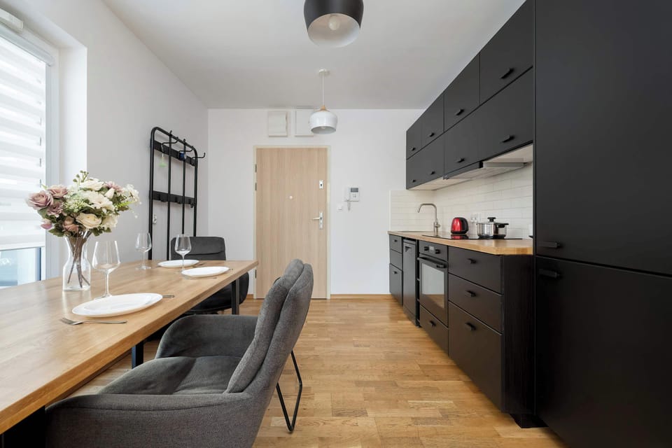 The kitchen's sleek design includes all necessary cookware and utensils.