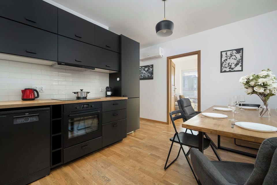The kitchen's contemporary decor complements the apartment's style.