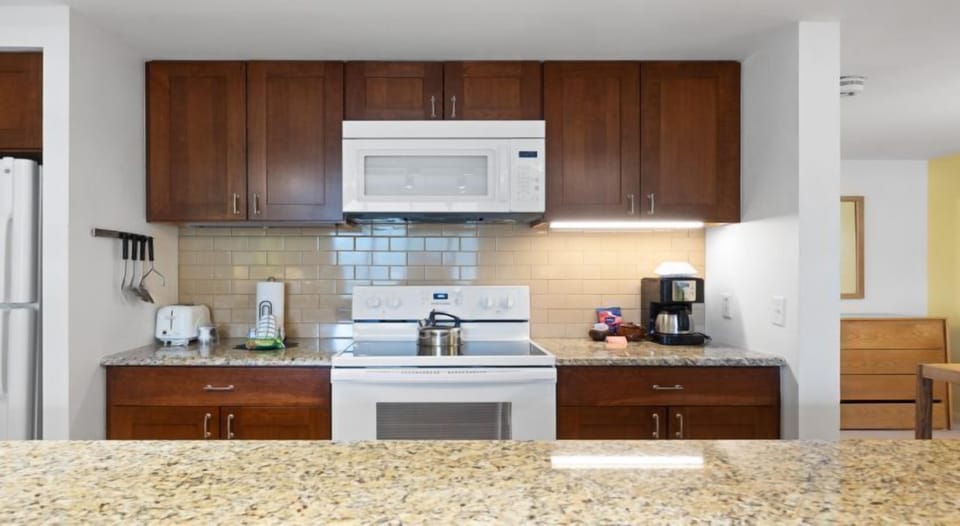 The modern kitchen setup, complete with essential appliances, ensures you have everything you need for a comfortable getaway.