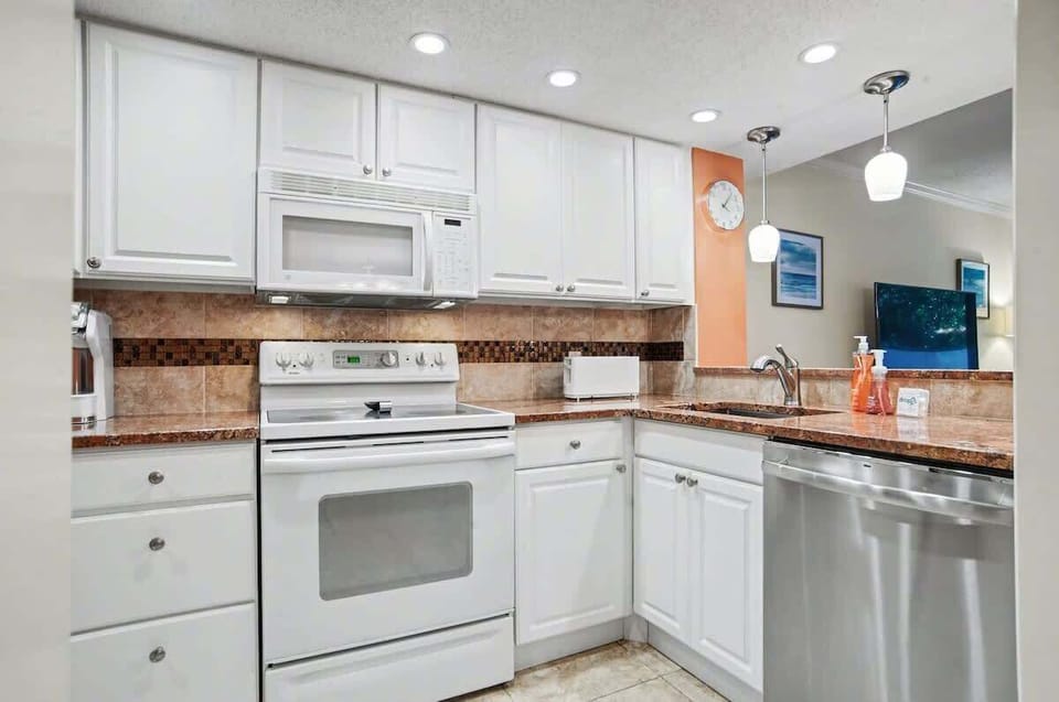 Your fully equipped kitchen features modern appliances and elegant granite countertops, perfect for preparing meals during your stay.