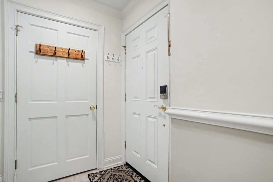 Step into your private entryway with convenient coat hooks and storage for all your belongings.