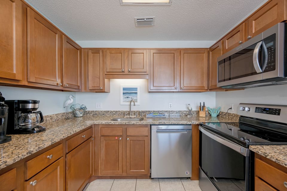 Your kitchen invites you to brew fresh coffee and prepare meals with granite counters all around you