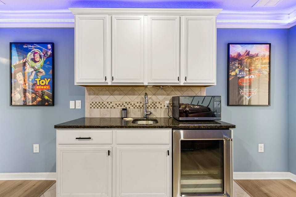 Includes sink, mini fridge, microwave, and bar seating — perfect for snacks, drinks, and movie nights.