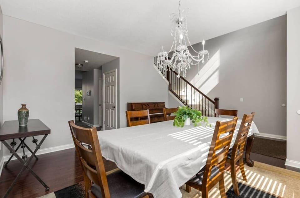 Elegant dining space w/ chandelier lighting & table set for shared meals.
