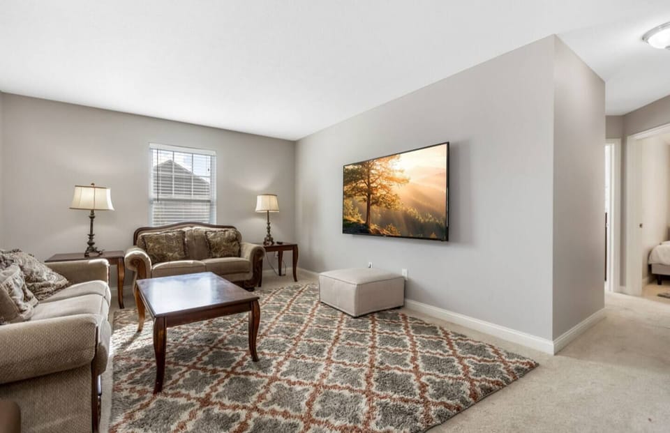Cozy sitting area w/ armchairs, coffee table, & soft lighting for relaxed evenings.