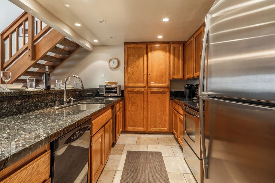 Your fully equipped kitchen features granite counters, stainless steel appliances, and everything needed to create memorable meals during your stay.