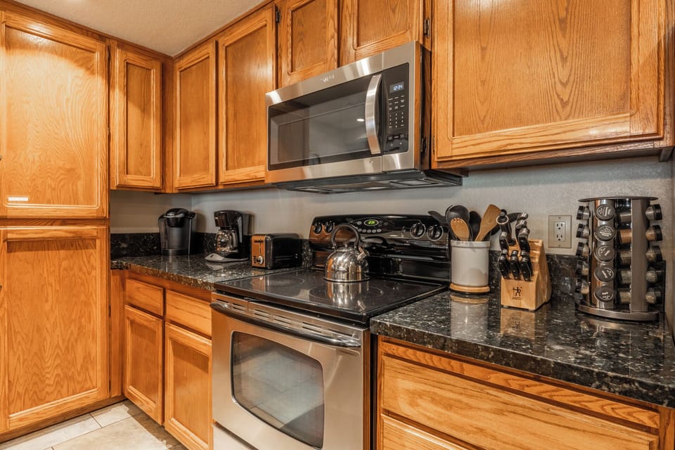 Cook your favorite meals in this well-equipped kitchen featuring granite countertops, stainless steel appliances, and everything you need for a perfect stay.