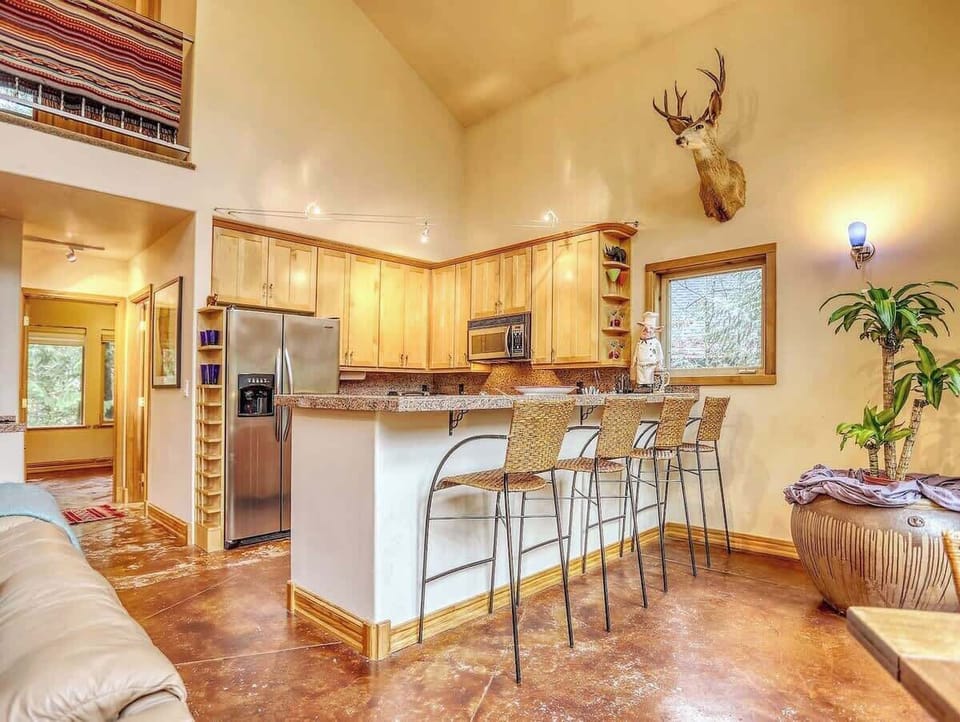 Breakfast bar area for relaxing or chatting with the family chef!  View from the dining table area.