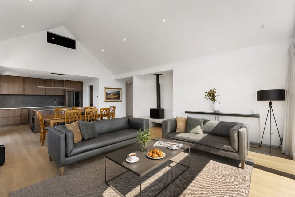 Spacious open-plan living designed for togetherness. A wood burner, generous seating, and a relaxed dining area all under soaring ceilings.