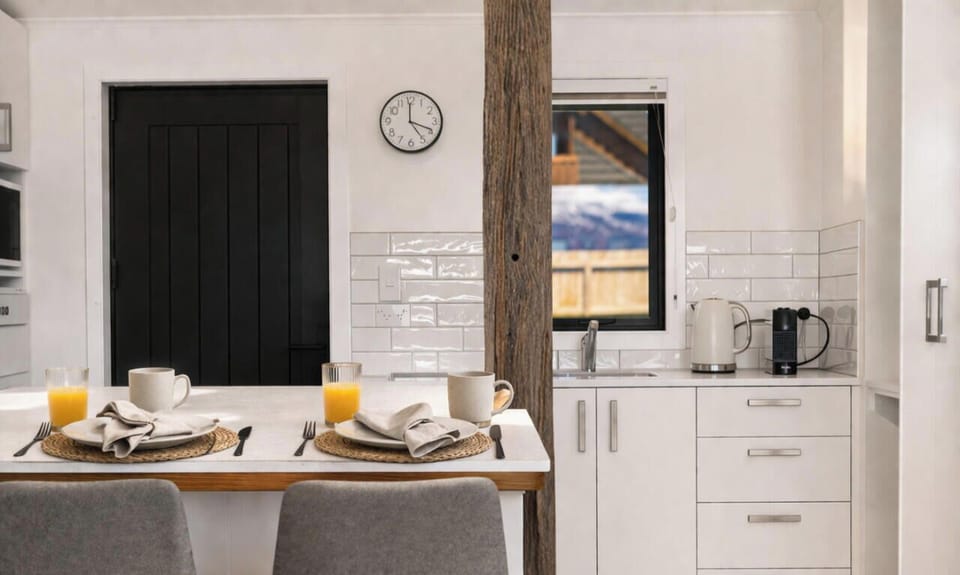 Cosy dining nook with subway tiles and mountain glimpses through the window
