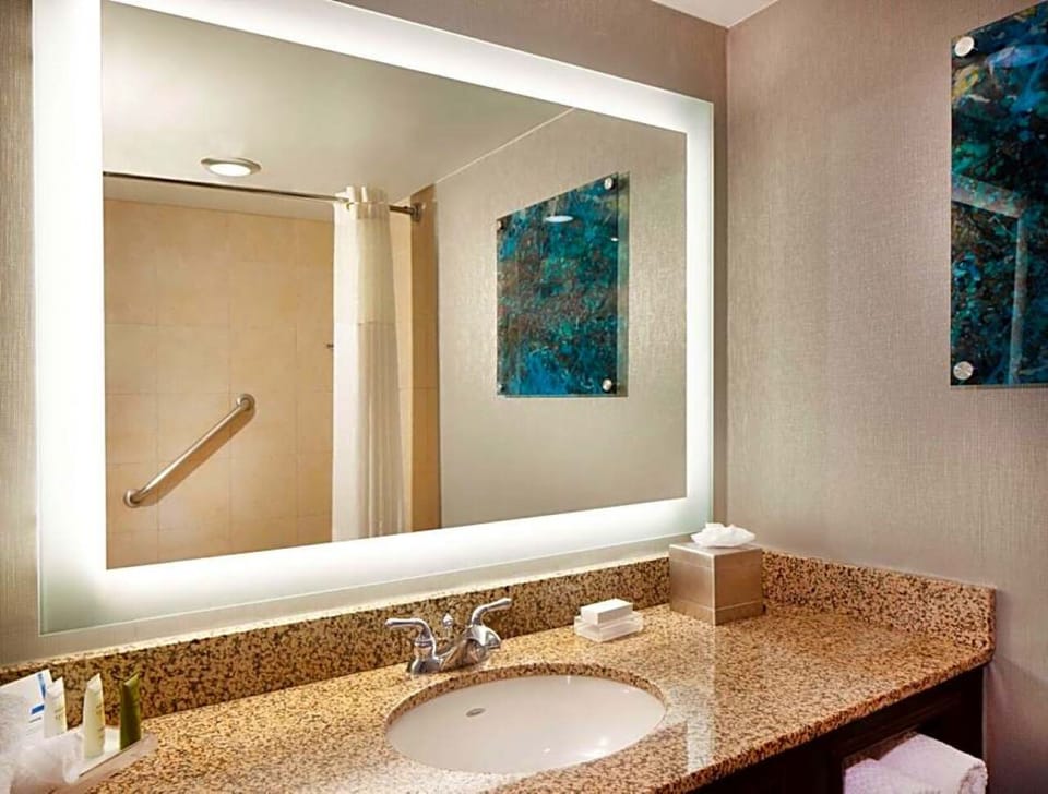 Freshen up at a gleaming vanity under bright, flattering lighting.