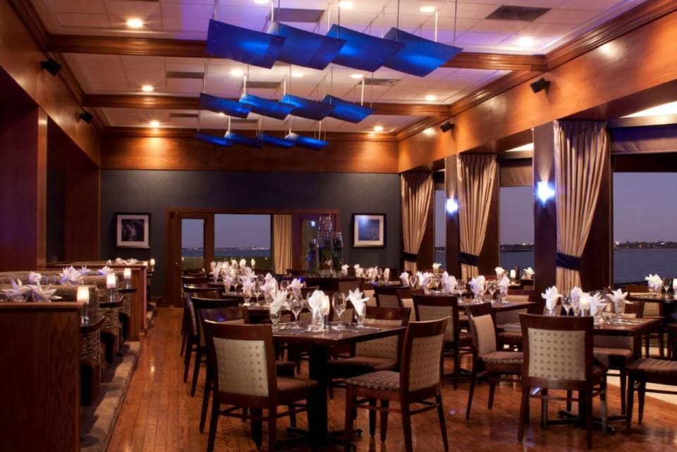 Dine by candlelight in an elegant waterfront restaurant setting.