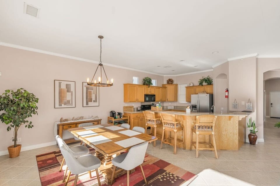 Open dining area w/ large table and kitchen connection, ideal for shared meals and easy gatherings.