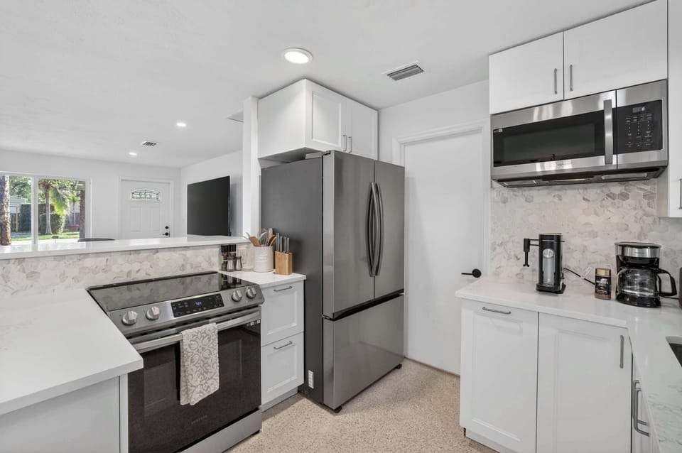 Clean and functional kitchen stocked with essential cookware and appliances for home-cooked meals.
