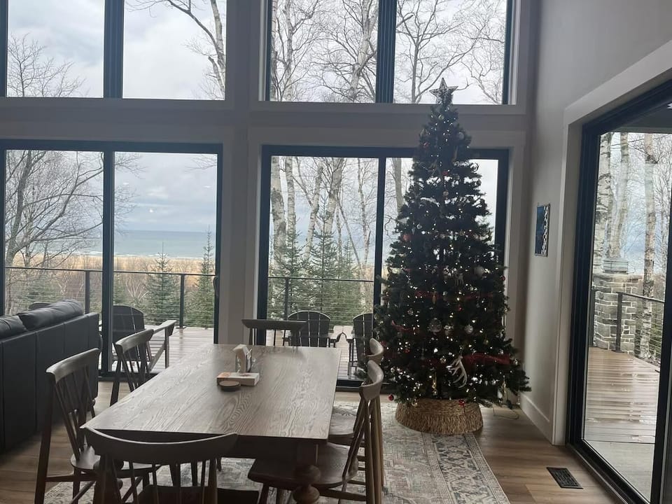 Sunlit dining area with panoramic forest views and cozy ambiance