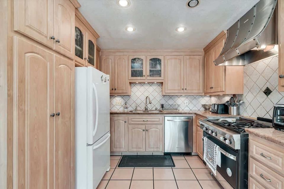 Spacious kitchen with modern appliances and warm cabinetry