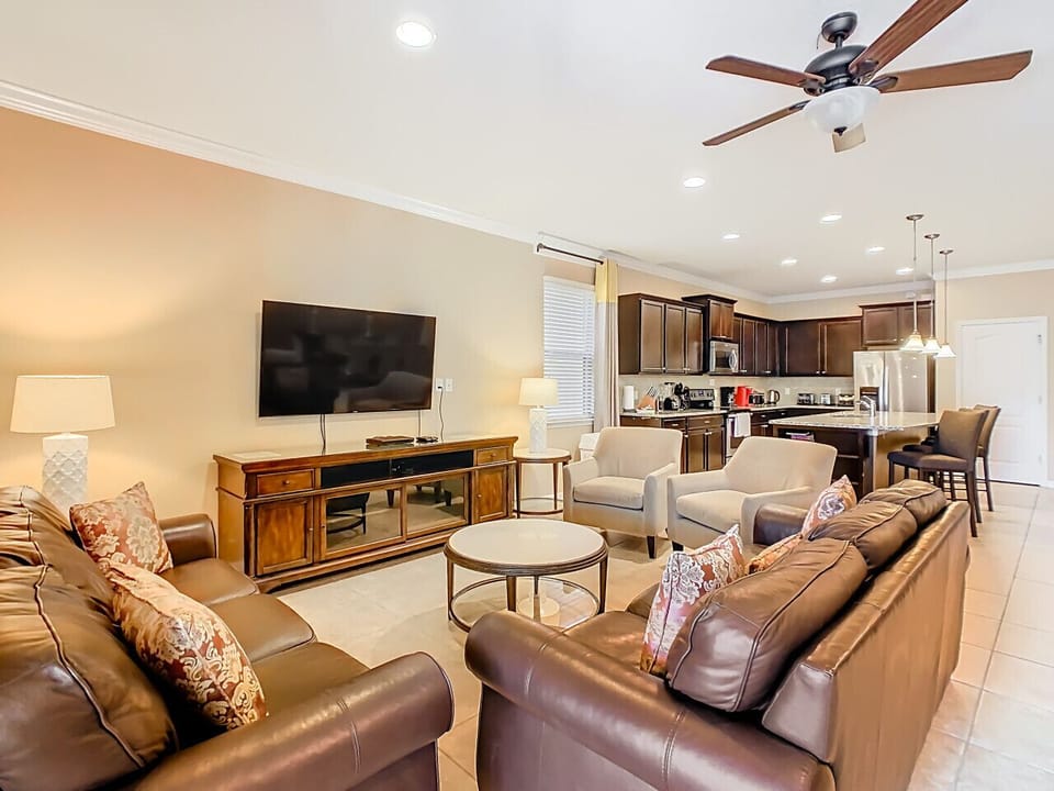Bright and comfortable living area with ample seating and a flat-screen TV.