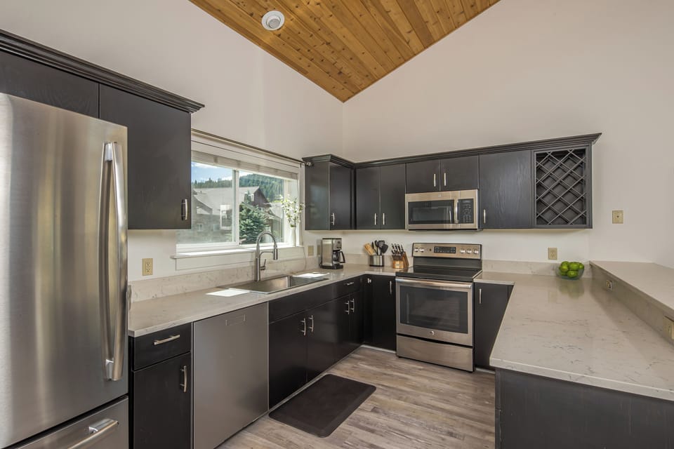 Modern style kitchen with stainless steel appliances and a large basin sink to complete an ultimate cooking experience | Main Level
