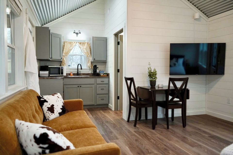 Modern rustic retreat: cozy lounge, dining nook, and kitchenette