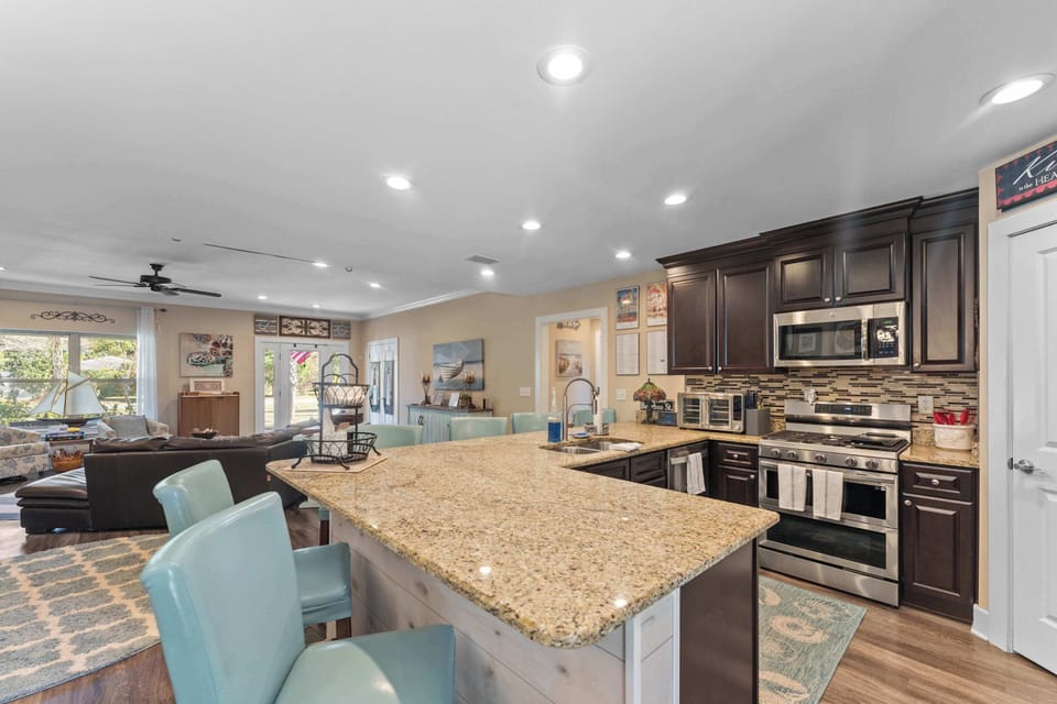 Fully stocked kitchen with stainless steel appliances.