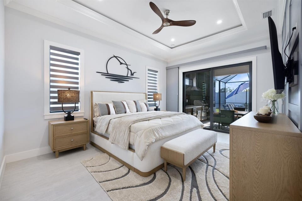 Master suite: King bed, TV, and modern LED ceiling trim lighting.