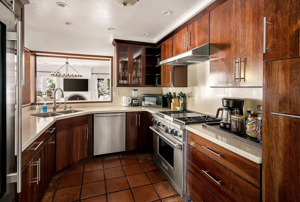 Cook with ease in this bright, thoughtfully stocked kitchen, perfect for everything from quick breakfasts to family dinners after a day in the California sun.