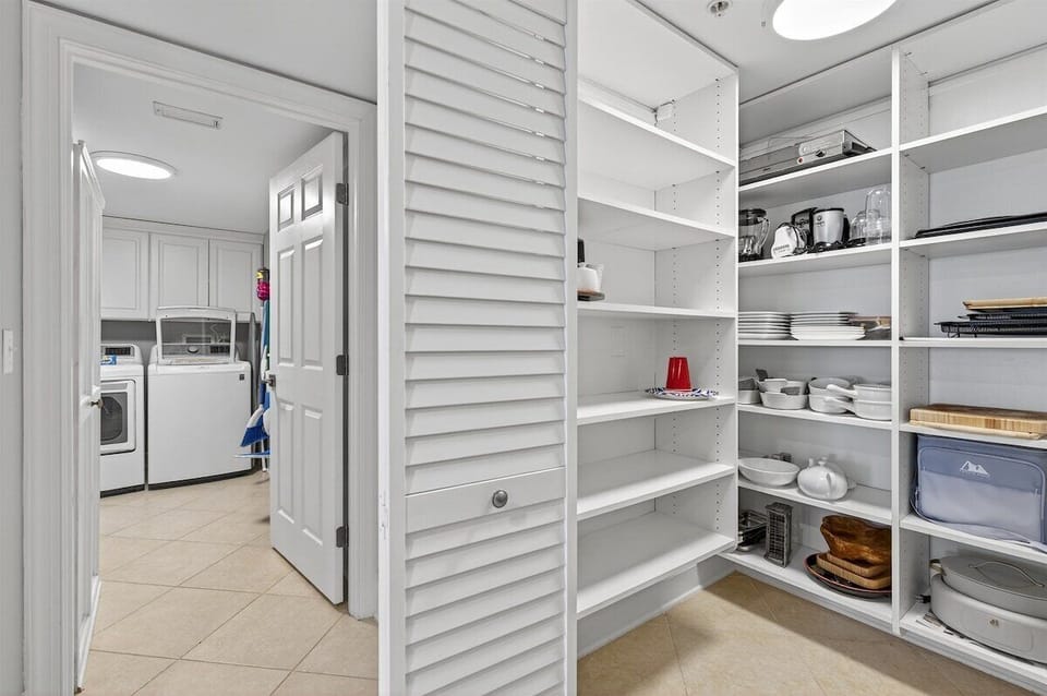 Large pantry and laundry room with a full sized washer/dryer