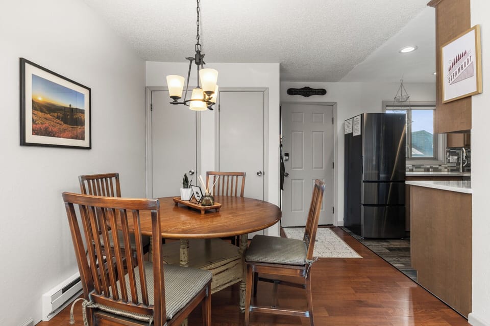 Round Wooden Dining Room Table that seats 4 with High Back Spindle Chairs with Upholstered Seat Cushions
