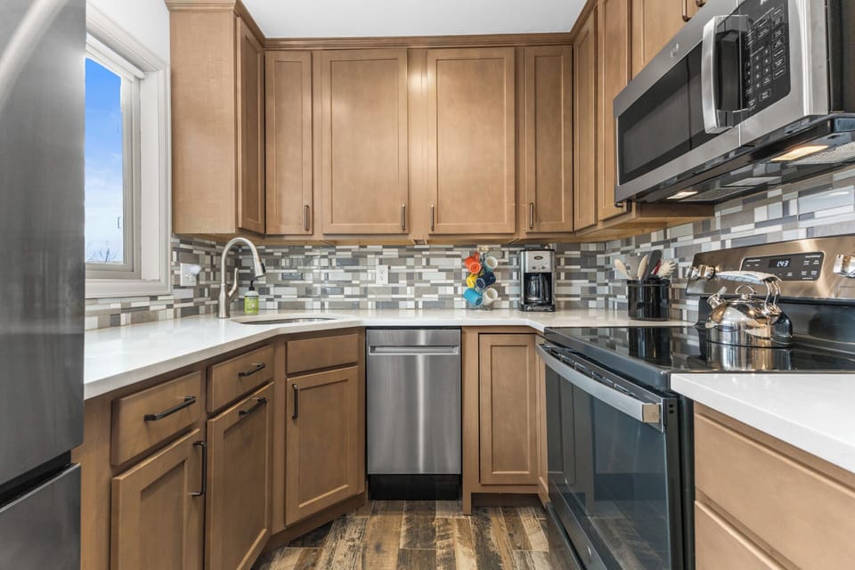 Stainless Steel Appliances including Electric Range with over the range Microwave and Dishwasher