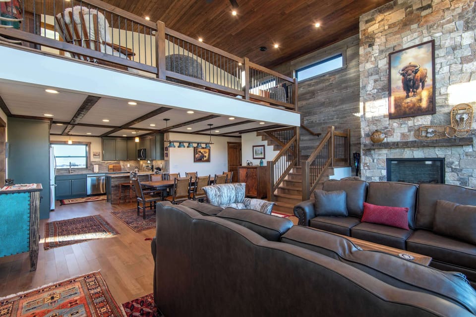 Open floor plan with living room, kitchen, dining, and upper family space