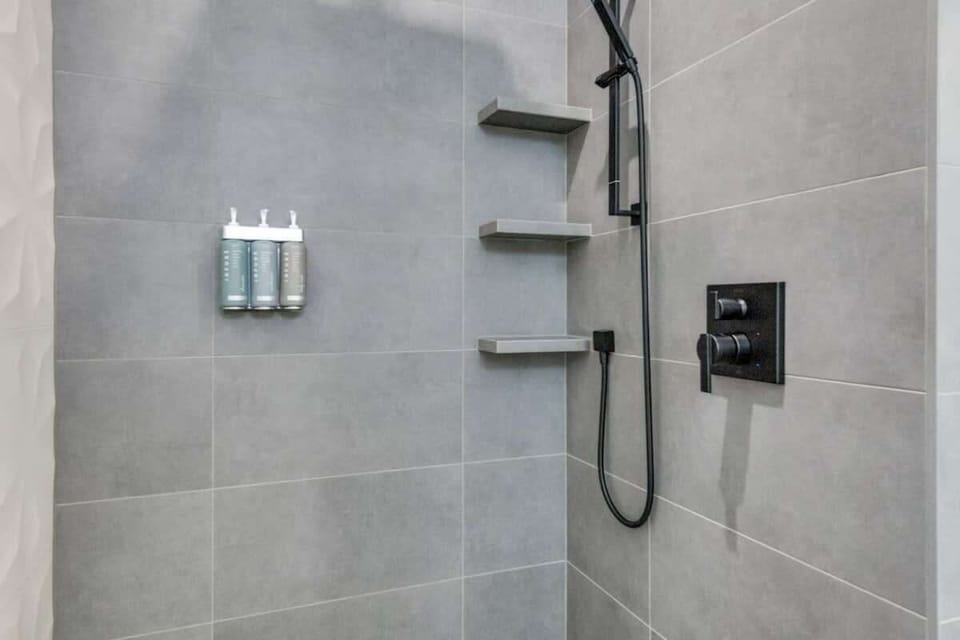 Walk-in shower with modern fixtures provides another comfortable full-bath option for families and groups sharing the home.

Spa quality shampoo, conditioner, and body wash provided in every shower.